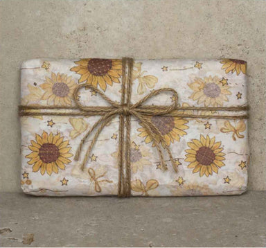 Clay & Colour Gift Wrap - Packaged product with sunflower design and twine bow on a textured background