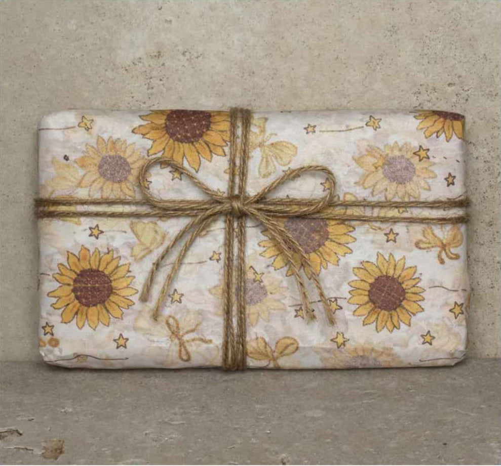 Clay & Colour Gift Wrap - Packaged product with sunflower design and twine bow on a textured background