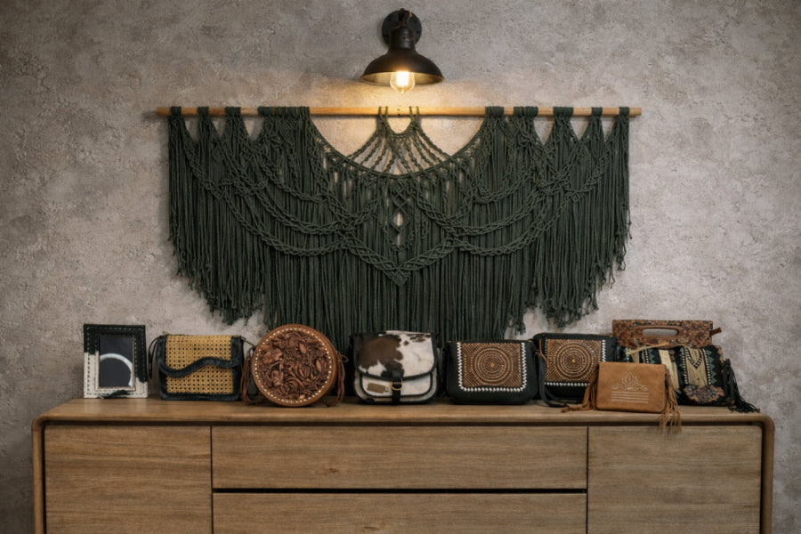 Woven bags displayed on a wooden dresser with a macrame wall hanging above.